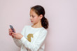 © Inna - Beautiful young girl using modern smartpone, hipster child blogger typing text message on her cellphone.
