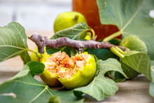 A Fresh Green Fig Tree Branch, Leaves, Ripe Figs And Vintage Glass Bottle With Fig Preserve / Jam. 