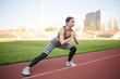 © Павел Костенко - Beautiful athletic girl warming up before a hard workout at the stadium