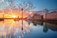 Dusseldorf, Germany. Cityscape Image Of Düsseldorf, Germany With The Media Harbour And Reflection Of The City In The Rhine River, During Sunrise.
