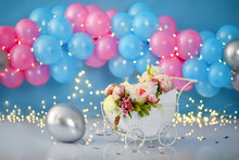 Colorful Decoration Background With Stroller, Flowers And Balloons For A First Birthday Party