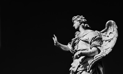 Wall Mural - Angel statue holding the Nails of Jesus Cross. A 17th century baroque masterpiece at the top of Sant'Angelo Bridge in the center of Rome (Black and White with copy space)