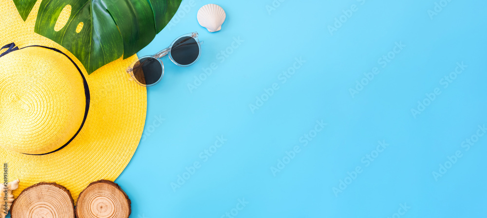 summer blue banner with yellow hat ,sunglasses,seashell and monstera leaf on blue background top view. - obrazy, fototapety, plakaty 