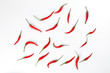 © oqba - Fresh birds eye red chilli scattered top view on white background