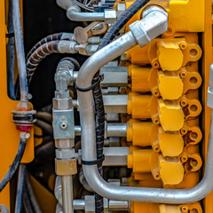 Details of a yellow construction machinery with close up on its engine