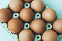 A Dozen Of Brown Eggs From Happy Hens In An Egg Carton