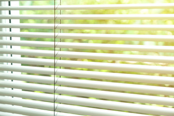 Blinds on the Windows in a bright room.