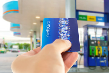 Credit card with mobile phone to make a payment for refueling car on gas station