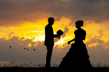 Wall Mural - Bride and groom at sunset