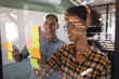 © Wavebreak Media - Business people writing on sticky notes in office