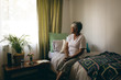 © Wavebreak Media - Senior woman sitting on bed at retirement home