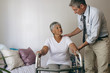 © Wavebreak Media - Male doctor helping senior female patient to walk with walker