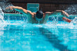 © Wavebreak Media - Young male swimmer with swim goggle swimming at swimming pool