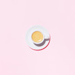 © Olga Zarytska - A cup of coffee on pink background. Trendy minimal styled flat lay photography with cappuccino.