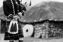Traditional Scottish Bagpiper In Full Dress