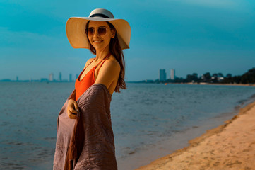 Beautiful woman with red swimsuit on the beach in Summer 