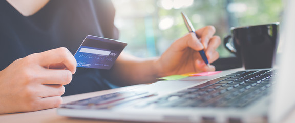 Business women use credit cards and laptop computer.