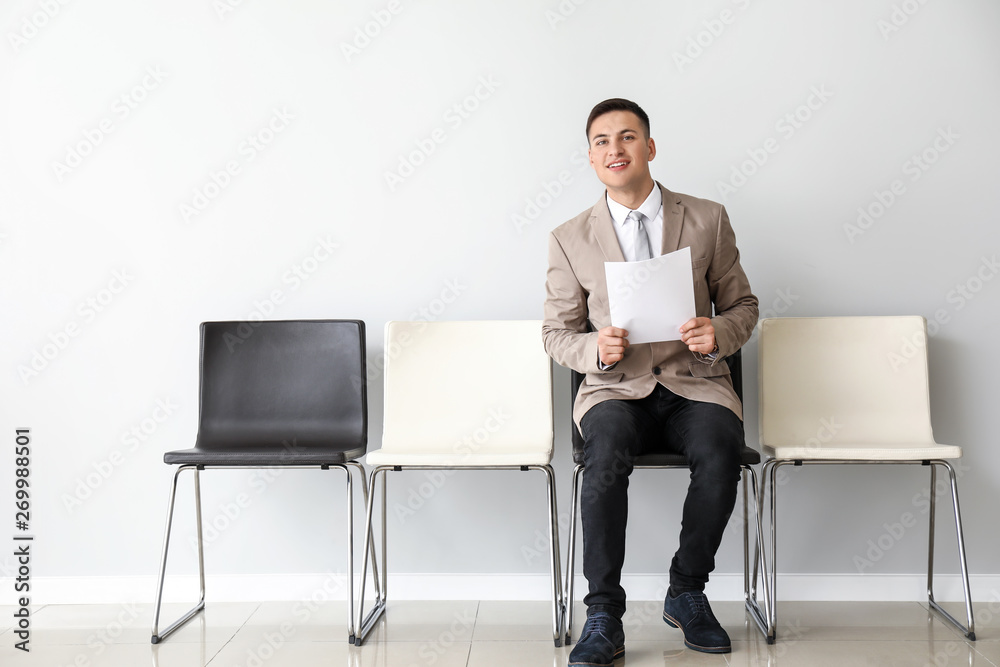 Young man waiting for job interview indoors