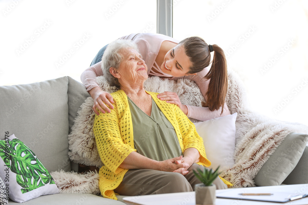 Caregiver with senior woman in nursing home - obrazy, fototapety, plakaty 