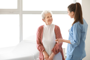 Poster - Medical worker with senior woman in nursing home