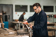 © bnenin - Men working a workshop in metal industry factory.