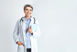© Pixel-Shot - Mature female doctor on light background