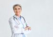 © Pixel-Shot - Mature female doctor on light background