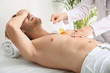 © Pixel-Shot - Young man suffering from pain during epilation in beauty salon