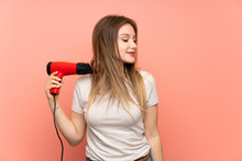 Teenager Girl Over Pink Background With Hair Dryer