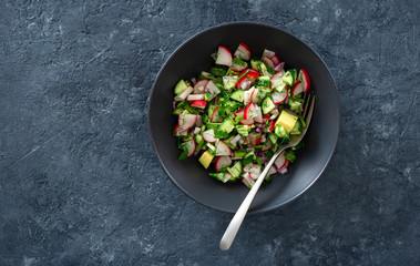 Wall Mural - Healthy salad bowl radish cucumber avocado top view