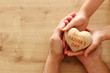 © tomertu - father and little child holding together wooden heart. Happy father's day concept.