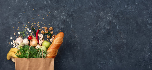 Wall Mural - Paper bag vegetables and fruit on a dark background with copy space top view. Bag food concept