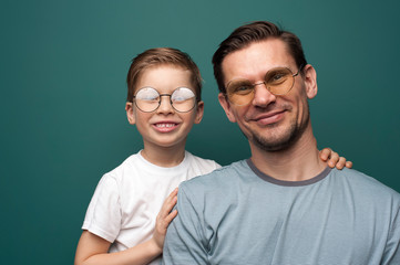 Shot of handsome caucasian father and son wearing stylish eyeglasses