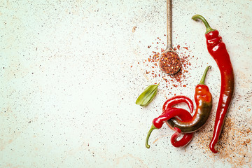 Red hot peppers on white stone background, top view with copy space.