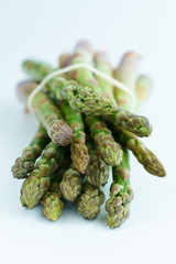 1 lb/0.5 kg of fresh organic asparagus on a white background. High resolution