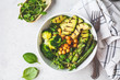 © vaaseenaa - Buddha bowl with grilled avocado, asparagus, chickpeas, pea sprouts and broccoli.