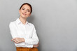 © Drobot Dean - Portrait of caucasian redhead businesswoman 20s in formal wear smiling at camera and posing in office