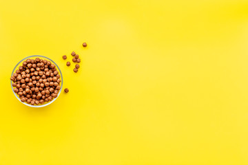 Cereals and flakes from corn and oat on yellow background top view mockup