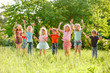 © Andrey - a group of children playing and running in the park on a green gozon.