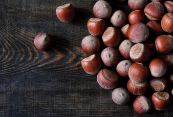 Hazelnut close up. Hazelnuts nuts on wooden background.