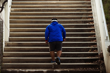 The fat man was running up the stairs. He lost weight.