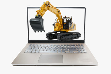 Excavator model on laptop with  isolated white background and concept strong in the construction industry and technology