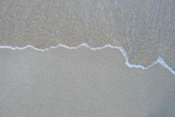 Soft wave ocean on sandy beach. Background.