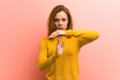 © Asier - Young pretty young woman showing a timeout gesture.