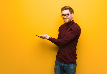 Young smart man holding something with hands