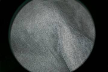 Wall Mural - Denim material in the frame of the round frame of the lamp.