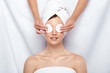 © veles_studio - beautician closing woman's eyes with two cotton pads