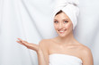 © veles_studio - attractive young lady in bath towel on head pretending that she holding something on her arm