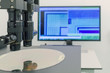 Silicon wafer on machine process examining in microscope.