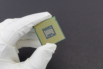 Poster - Hand in white glove holding a CPU computer processor microchip.